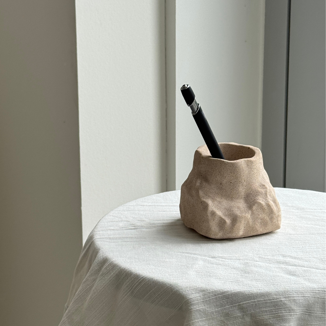 hand-poured micro concrete pen holder, almond beige stone-look finish, modern and minimalist desk organizer, stylish office decor, functional pen holder for home office, unique desk accessory, eco-friendly concrete desk storage, high-quality office supplies, contemporary home decor, versatile storage solution for pens, pencils, and office tools, sculptural office decor, perfect for desk or workspace, gift-ready pen holder, sustainable home office piece, elegant and practical desk organization, ginaladeco