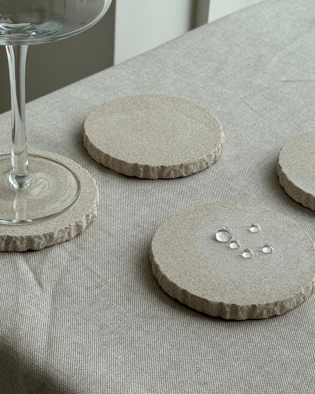 hand-poured micro concrete coasters, modern almond beige stone-look finish, minimalist drink coasters, functional and stylish drink accessories, high-quality concrete home decor, eco-friendly coaster set, contemporary table decor, unique coasters for home, sustainable coasters for drinks, premium concrete drinkware, handmade coasters for dining or living room, versatile coaster set for glass, mug, or cup, perfect gift for home decor lovers, elegant and durable home accessories, ginaladeco