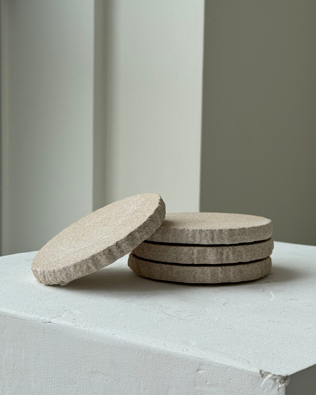 hand-poured micro concrete coasters, modern almond beige stone-look finish, minimalist drink coasters, functional and stylish drink accessories, high-quality concrete home decor, eco-friendly coaster set, contemporary table decor, unique coasters for home, sustainable coasters for drinks, premium concrete drinkware, handmade coasters for dining or living room, versatile coaster set for glass, mug, or cup, perfect gift for home decor lovers, elegant and durable home accessories, ginaladeco