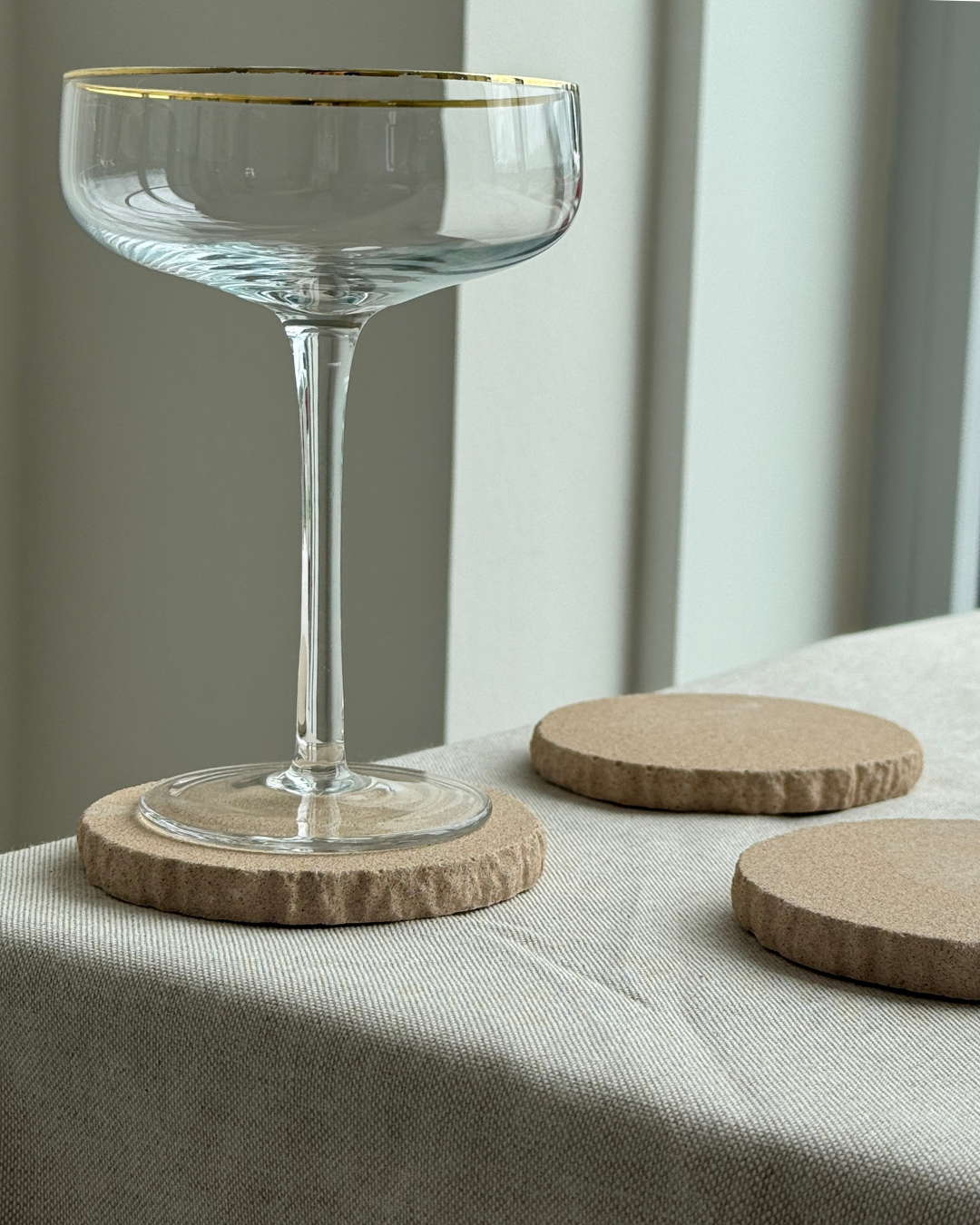 hand-poured micro concrete coasters, modern almond beige stone-look finish, minimalist drink coasters, functional and stylish drink accessories, high-quality concrete home decor, eco-friendly coaster set, contemporary table decor, unique coasters for home, sustainable coasters for drinks, premium concrete drinkware, handmade coasters for dining or living room, versatile coaster set for glass, mug, or cup, perfect gift for home decor lovers, elegant and durable home accessories, ginaladeco