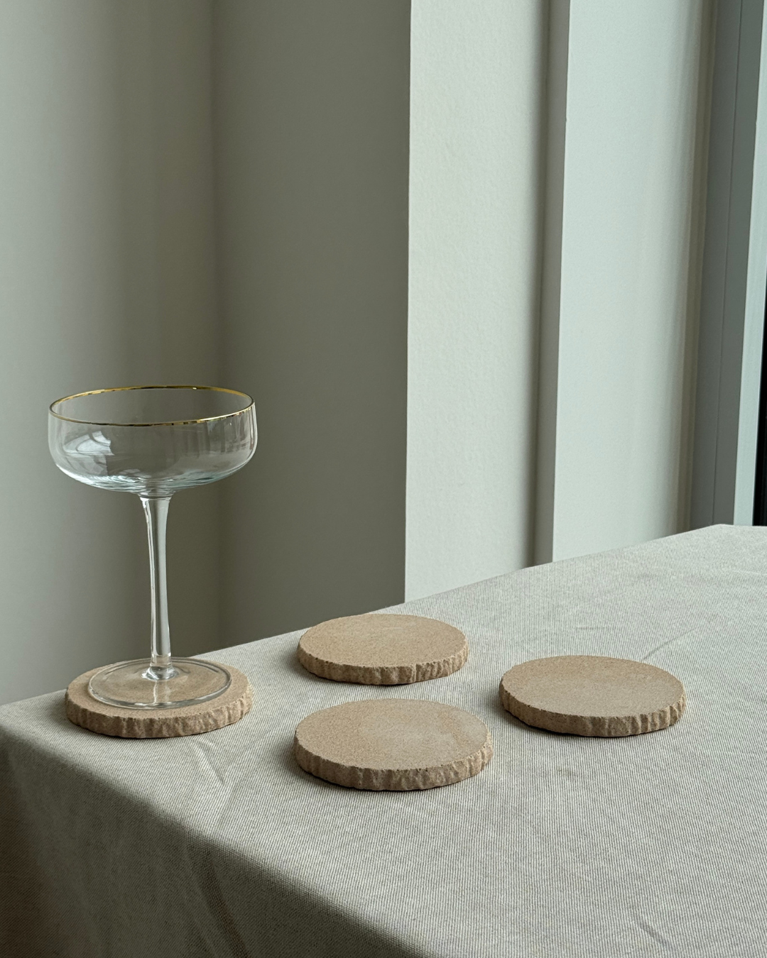 hand-poured micro concrete coasters, modern almond beige stone-look finish, minimalist drink coasters, functional and stylish drink accessories, high-quality concrete home decor, eco-friendly coaster set, contemporary table decor, unique coasters for home, sustainable coasters for drinks, premium concrete drinkware, handmade coasters for dining or living room, versatile coaster set for glass, mug, or cup, perfect gift for home decor lovers, elegant and durable home accessories, ginaladeco