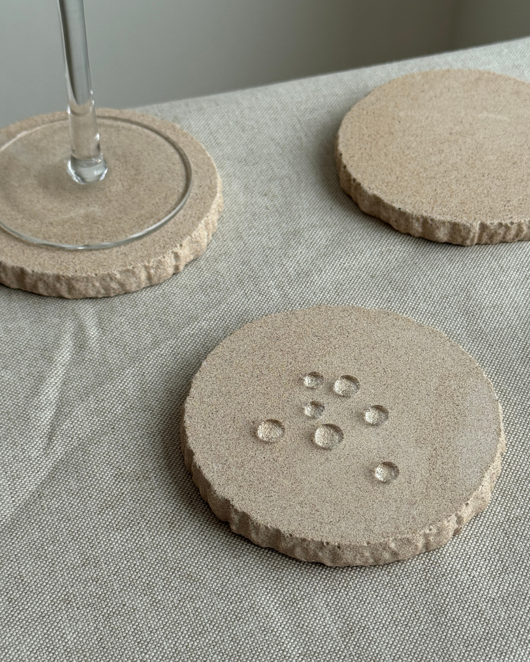 hand-poured micro concrete coasters, modern almond beige stone-look finish, minimalist drink coasters, functional and stylish drink accessories, high-quality concrete home decor, eco-friendly coaster set, contemporary table decor, unique coasters for home, sustainable coasters for drinks, premium concrete drinkware, handmade coasters for dining or living room, versatile coaster set for glass, mug, or cup, perfect gift for home decor lovers, elegant and durable home accessories, ginaladeco
