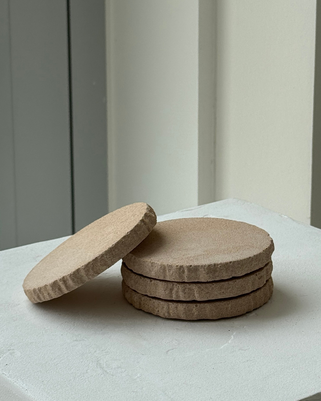 hand-poured micro concrete coasters, modern almond beige stone-look finish, minimalist drink coasters, functional and stylish drink accessories, high-quality concrete home decor, eco-friendly coaster set, contemporary table decor, unique coasters for home, sustainable coasters for drinks, premium concrete drinkware, handmade coasters for dining or living room, versatile coaster set for glass, mug, or cup, perfect gift for home decor lovers, elegant and durable home accessories, ginaladeco