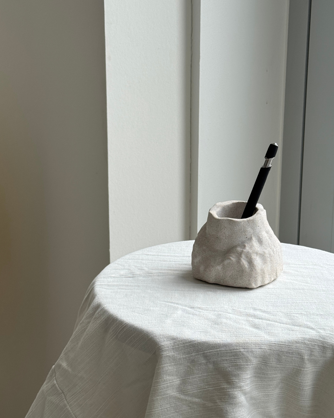 hand-poured micro concrete pen holder, almond beige stone-look finish, modern and minimalist desk organizer, stylish office decor, functional pen holder for home office, unique desk accessory, eco-friendly concrete desk storage, high-quality office supplies, contemporary home decor, versatile storage solution for pens, pencils, and office tools, sculptural office decor, perfect for desk or workspace, gift-ready pen holder, sustainable home office piece, elegant and practical desk organization, ginaladeco