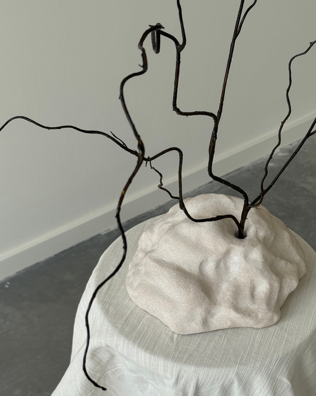 hand-poured micro concrete sculpture, modern minimalist art piece, unique concrete decor, sculptural home accent, almond beige stone-look finish, functional art object, vase for single branch or stem, contemporary decor for living room or office, eco-friendly sculptural piece, high-quality concrete art, handmade decor for modern homes, statement art piece, functional decorative sculpture, versatile decor for floral arrangements, premium home decor, bespoke design sculpture, handmade art for home styling, gi