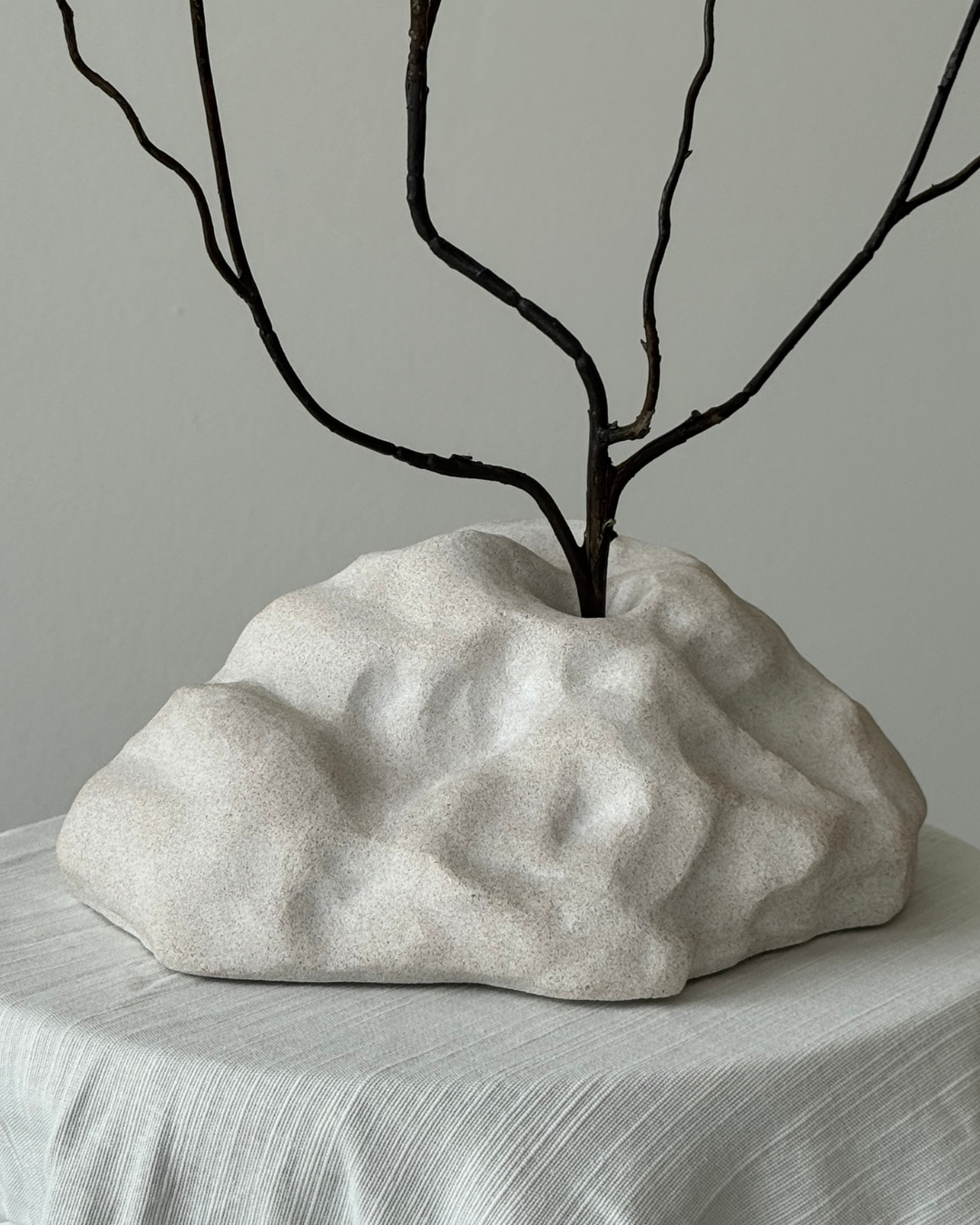 hand-poured micro concrete sculpture, modern minimalist art piece, unique concrete decor, sculptural home accent, almond beige stone-look finish, functional art object, vase for single branch or stem, contemporary decor for living room or office, eco-friendly sculptural piece, high-quality concrete art, handmade decor for modern homes, statement art piece, functional decorative sculpture, versatile decor for floral arrangements, premium home decor, bespoke design sculpture, handmade art for home styling, gi