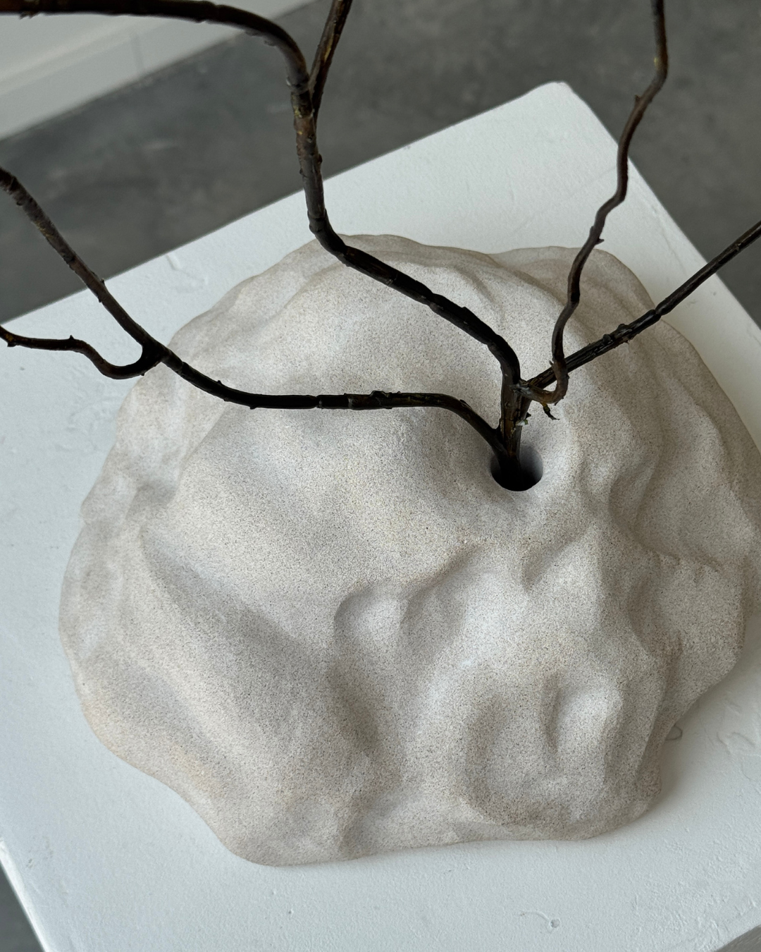 hand-poured micro concrete sculpture, modern minimalist art piece, unique concrete decor, sculptural home accent, almond beige stone-look finish, functional art object, vase for single branch or stem, contemporary decor for living room or office, eco-friendly sculptural piece, high-quality concrete art, handmade decor for modern homes, statement art piece, functional decorative sculpture, versatile decor for floral arrangements, premium home decor, bespoke design sculpture, handmade art for home styling, gi