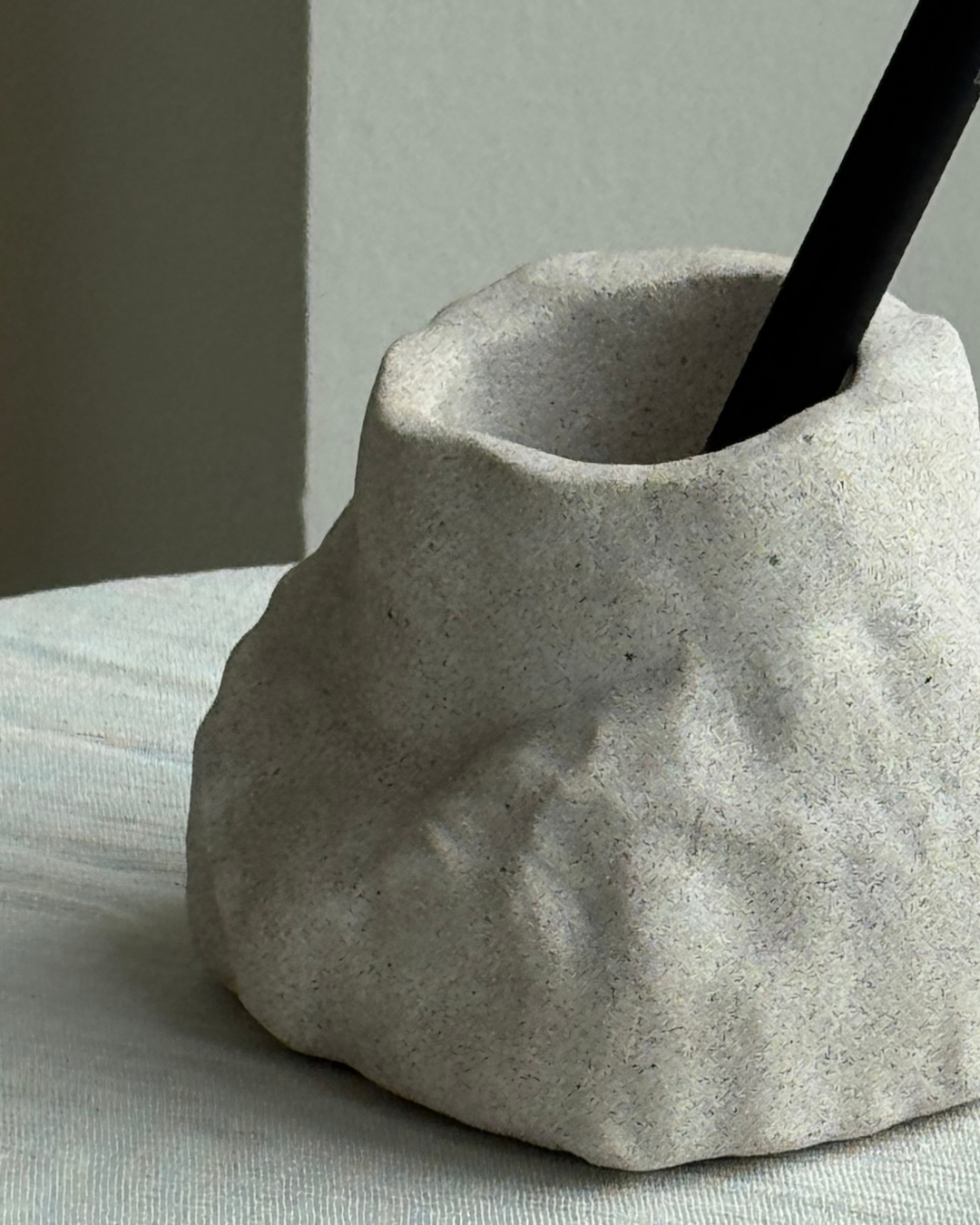 hand-poured micro concrete pen holder, almond beige stone-look finish, modern and minimalist desk organizer, stylish office decor, functional pen holder for home office, unique desk accessory, eco-friendly concrete desk storage, high-quality office supplies, contemporary home decor, versatile storage solution for pens, pencils, and office tools, sculptural office decor, perfect for desk or workspace, gift-ready pen holder, sustainable home office piece, elegant and practical desk organization, ginaladeco