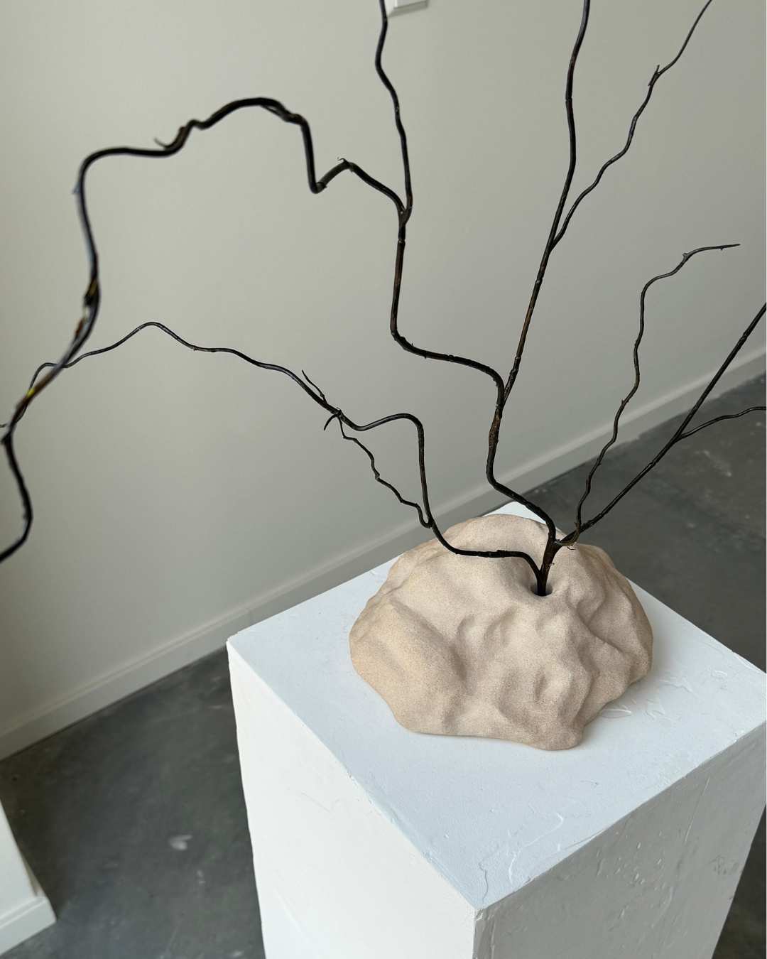 hand-poured micro concrete sculpture, modern minimalist art piece, unique concrete decor, sculptural home accent, almond beige stone-look finish, functional art object, vase for single branch or stem, contemporary decor for living room or office, eco-friendly sculptural piece, high-quality concrete art, handmade decor for modern homes, statement art piece, functional decorative sculpture, versatile decor for floral arrangements, premium home decor, bespoke design sculpture, handmade art for home styling, gi