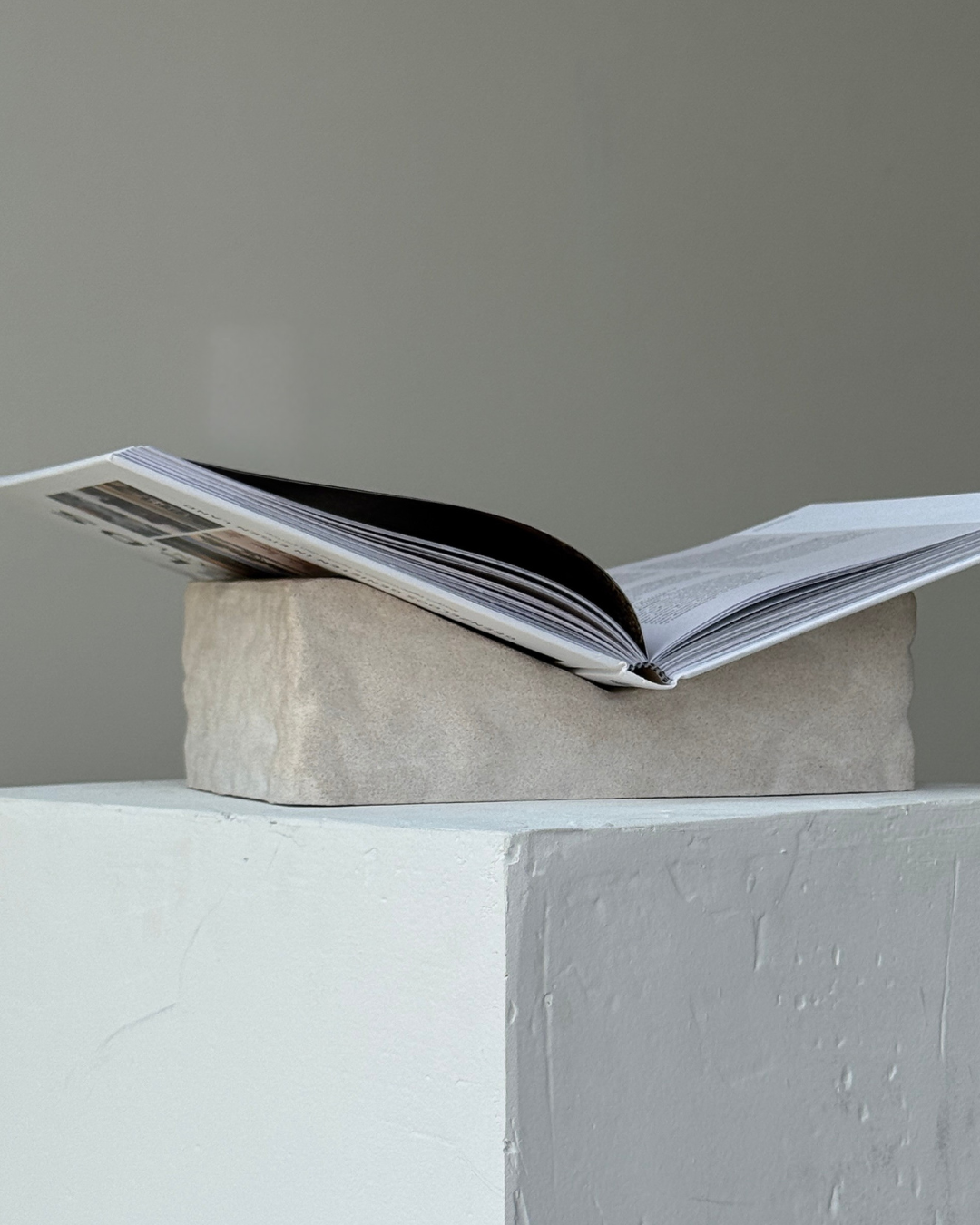 hand-poured micro concrete book stand, minimalist display stand for books and journals, sculptural home decor piece, modern concrete book holder, unique decorative stand, high-quality concrete home accessories, neutral almond beige finish, functional and stylish book organizer, contemporary art piece for home, versatile decor for living room or office, eco-friendly home decor, premium quality concrete stand, handmade sculptural decor, perfect for book lovers, unique gift idea, ginaladeco