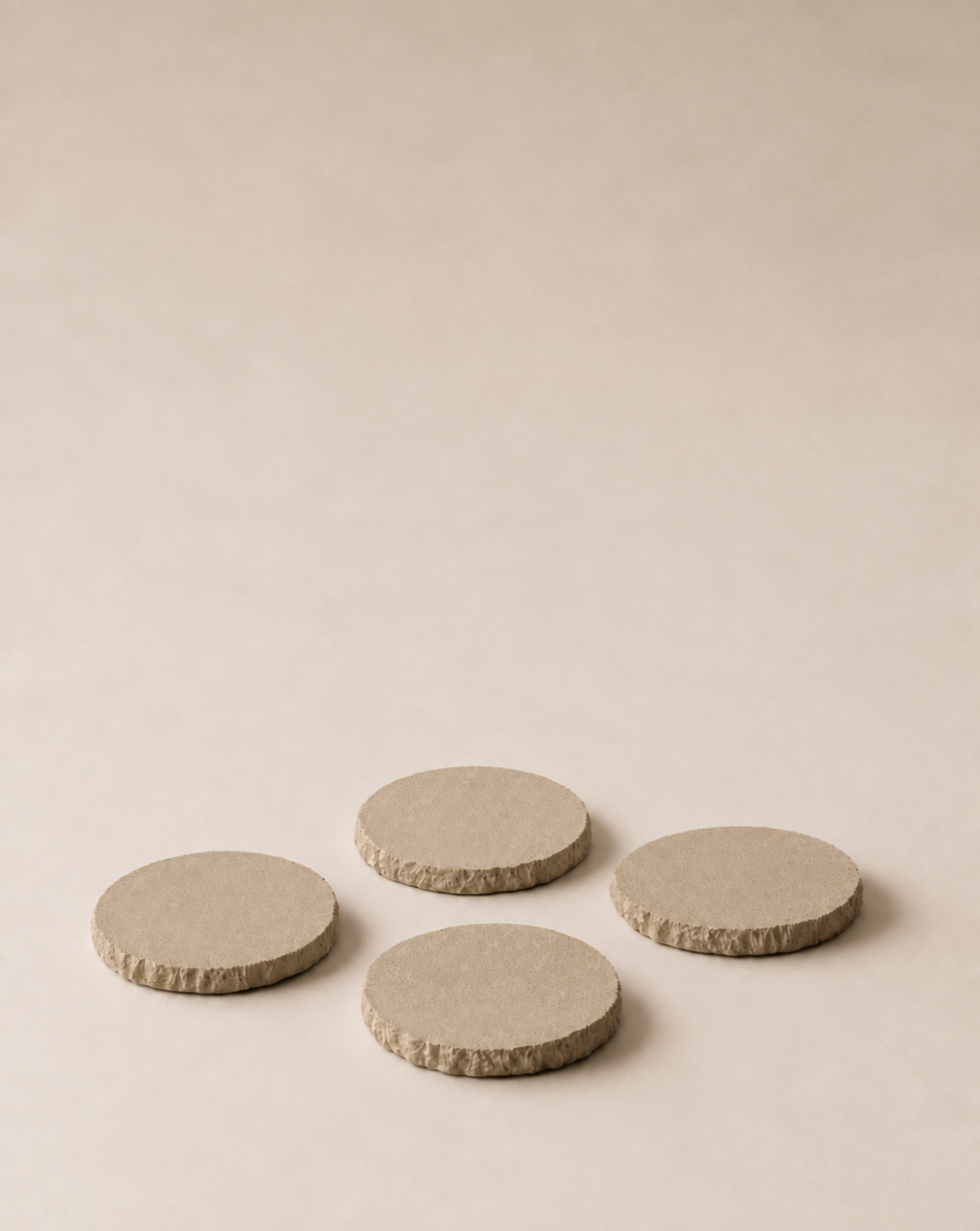 hand-poured micro concrete coasters, modern almond beige stone-look finish, minimalist drink coasters, functional and stylish drink accessories, high-quality concrete home decor, eco-friendly coaster set, contemporary table decor, unique coasters for home, sustainable coasters for drinks, premium concrete drinkware, handmade coasters for dining or living room, versatile coaster set for glass, mug, or cup, perfect gift for home decor lovers, elegant and durable home accessories, ginaladeco