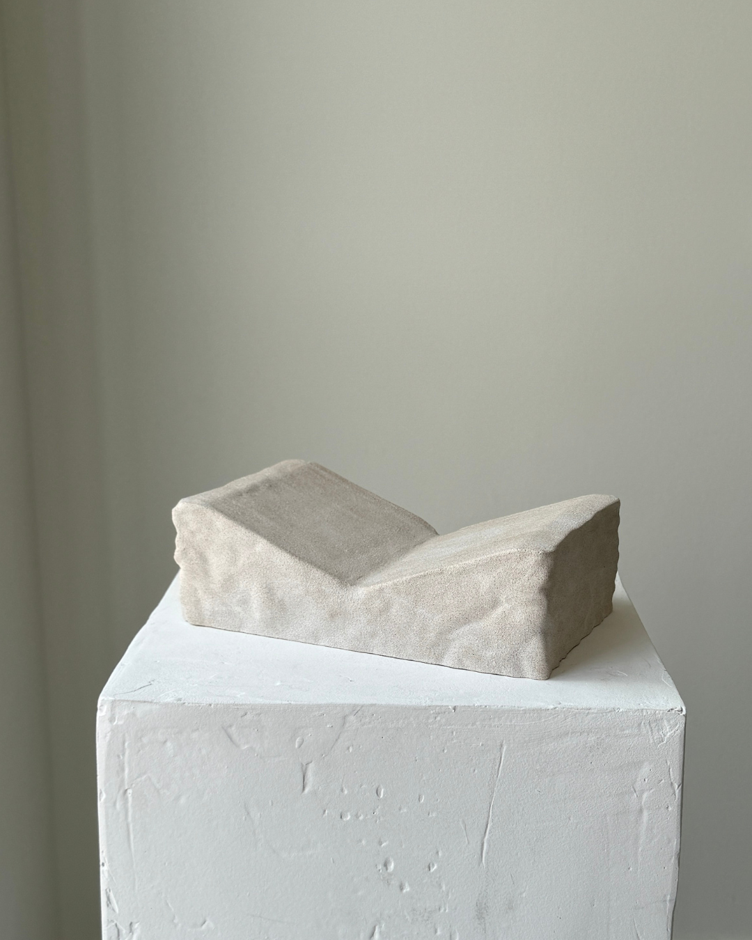 hand-poured micro concrete book stand, minimalist display stand for books and journals, sculptural home decor piece, modern concrete book holder, unique decorative stand, high-quality concrete home accessories, neutral almond beige finish, functional and stylish book organizer, contemporary art piece for home, versatile decor for living room or office, eco-friendly home decor, premium quality concrete stand, handmade sculptural decor, perfect for book lovers, unique gift idea, ginaladeco