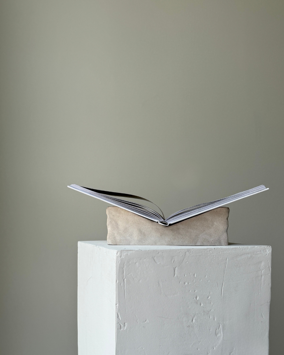 hand-poured micro concrete book stand, minimalist display stand for books and journals, sculptural home decor piece, modern concrete book holder, unique decorative stand, high-quality concrete home accessories, neutral almond beige finish, functional and stylish book organizer, contemporary art piece for home, versatile decor for living room or office, eco-friendly home decor, premium quality concrete stand, handmade sculptural decor, perfect for book lovers, unique gift idea, ginaladeco
