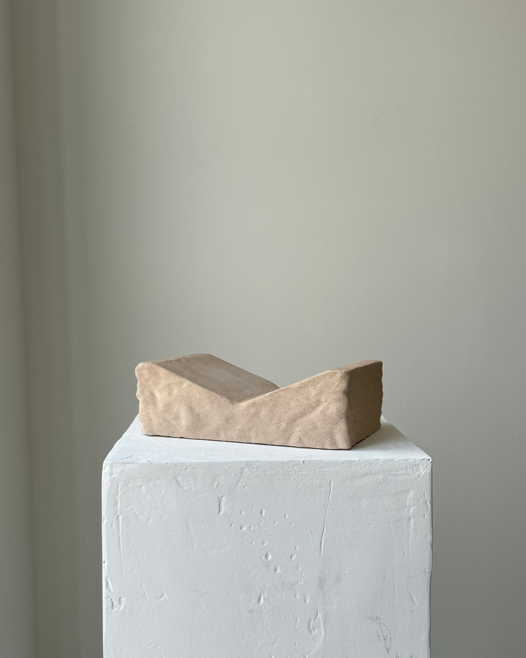 hand-poured micro concrete book stand, minimalist display stand for books and journals, sculptural home decor piece, modern concrete book holder, unique decorative stand, high-quality concrete home accessories, neutral almond beige finish, functional and stylish book organizer, contemporary art piece for home, versatile decor for living room or office, eco-friendly home decor, premium quality concrete stand, handmade sculptural decor, perfect for book lovers, unique gift idea, ginaladeco