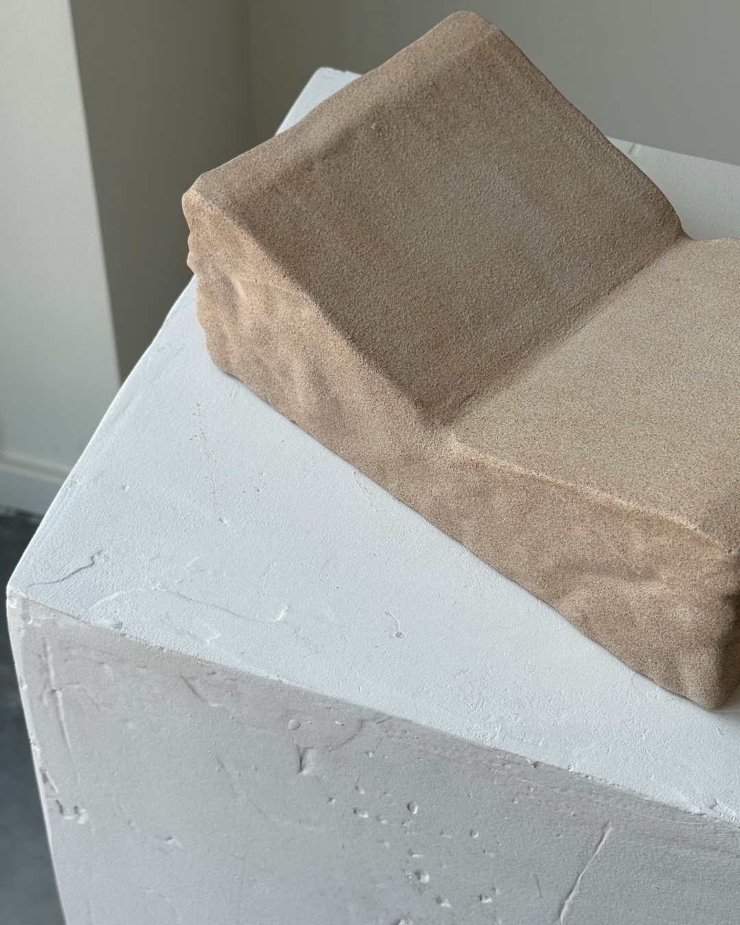 hand-poured micro concrete book stand, minimalist display stand for books and journals, sculptural home decor piece, modern concrete book holder, unique decorative stand, high-quality concrete home accessories, neutral almond beige finish, functional and stylish book organizer, contemporary art piece for home, versatile decor for living room or office, eco-friendly home decor, premium quality concrete stand, handmade sculptural decor, perfect for book lovers, unique gift idea, ginaladeco
