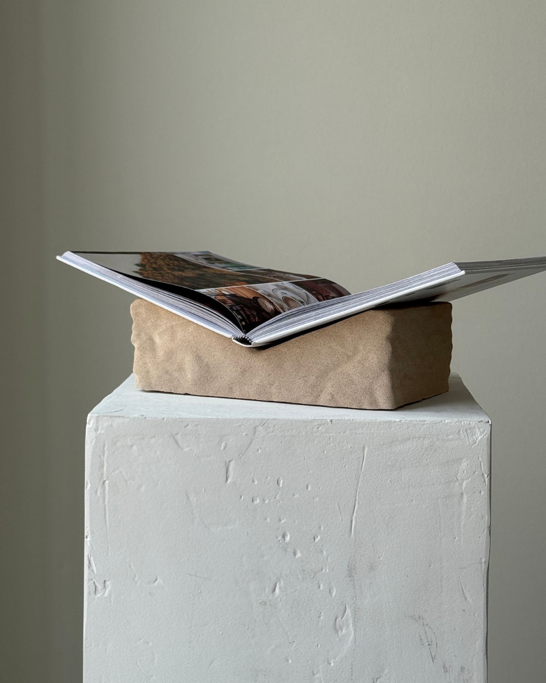 hand-poured micro concrete book stand, minimalist display stand for books and journals, sculptural home decor piece, modern concrete book holder, unique decorative stand, high-quality concrete home accessories, neutral almond beige finish, functional and stylish book organizer, contemporary art piece for home, versatile decor for living room or office, eco-friendly home decor, premium quality concrete stand, handmade sculptural decor, perfect for book lovers, unique gift idea, ginaladeco