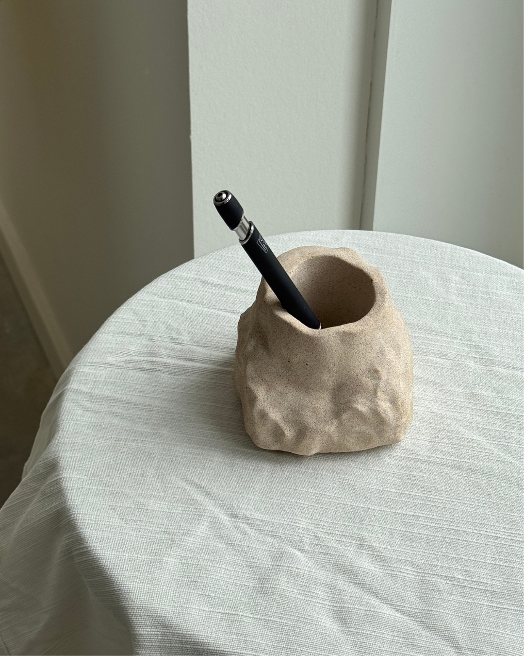 hand-poured micro concrete pen holder, almond beige stone-look finish, modern and minimalist desk organizer, stylish office decor, functional pen holder for home office, unique desk accessory, eco-friendly concrete desk storage, high-quality office supplies, contemporary home decor, versatile storage solution for pens, pencils, and office tools, sculptural office decor, perfect for desk or workspace, gift-ready pen holder, sustainable home office piece, elegant and practical desk organization, ginaladeco