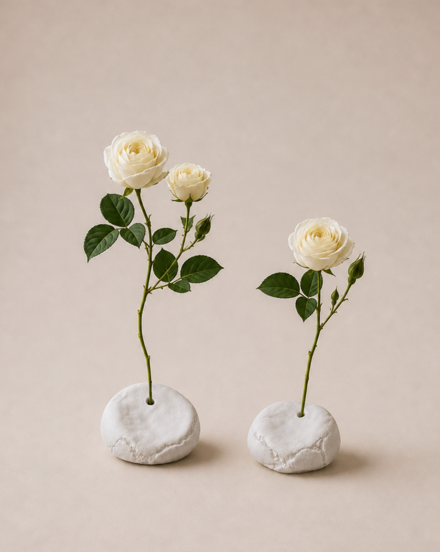minimalist interior, white roses, ceramic vases, handmade decor, pebble vases, sculptural objects, wooden shelf, window light, sunlight shadows, neutral tones, aesthetic decor, soft natural light, floral arrangement, modern home, calm atmosphere, windowsill styling, organic shapes, artisanal pottery, natural materials, simple living, serene space, cozy corner, contemporary design, clean aesthetic, still life, home styling