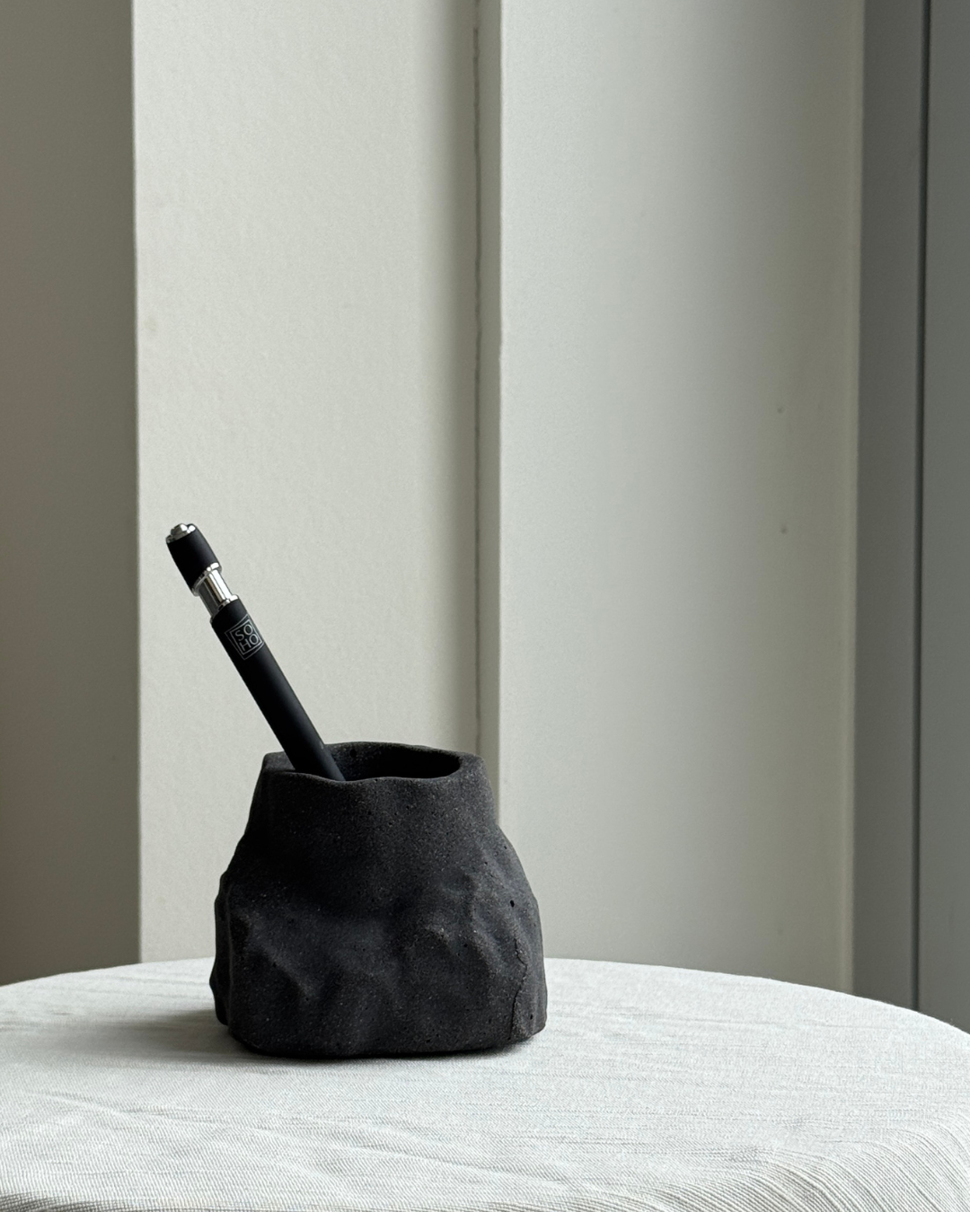 hand-poured micro concrete pen holder, almond beige stone-look finish, modern and minimalist desk organizer, stylish office decor, functional pen holder for home office, unique desk accessory, eco-friendly concrete desk storage, high-quality office supplies, contemporary home decor, versatile storage solution for pens, pencils, and office tools, sculptural office decor, perfect for desk or workspace, gift-ready pen holder, sustainable home office piece, elegant and practical desk organization, ginaladeco