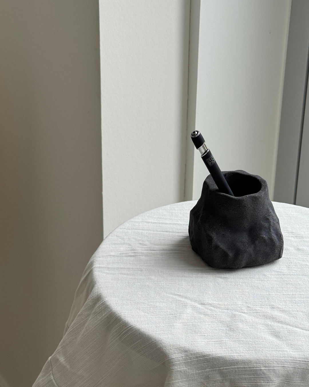 hand-poured micro concrete pen holder, almond beige stone-look finish, modern and minimalist desk organizer, stylish office decor, functional pen holder for home office, unique desk accessory, eco-friendly concrete desk storage, high-quality office supplies, contemporary home decor, versatile storage solution for pens, pencils, and office tools, sculptural office decor, perfect for desk or workspace, gift-ready pen holder, sustainable home office piece, elegant and practical desk organization, ginaladeco