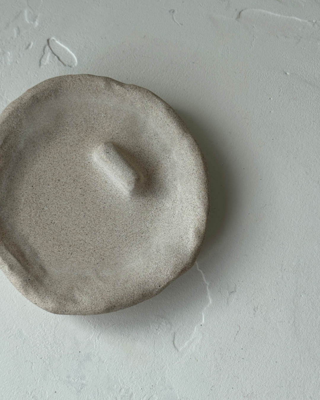 hand-poured micro concrete palo santo dish, modern stone-look finish, minimalist decor for palo santo burning, functional and sculptural home decor, almond beige color, elevated rest for palo santo stick, eco-friendly concrete dish, unique incense holder, contemporary decor for living room or meditation space, high-quality concrete home accessory, handmade dish for spiritual practices, versatile decorative object, premium concrete art piece, stylish and functional gift for wellness lovers, ginaladeco