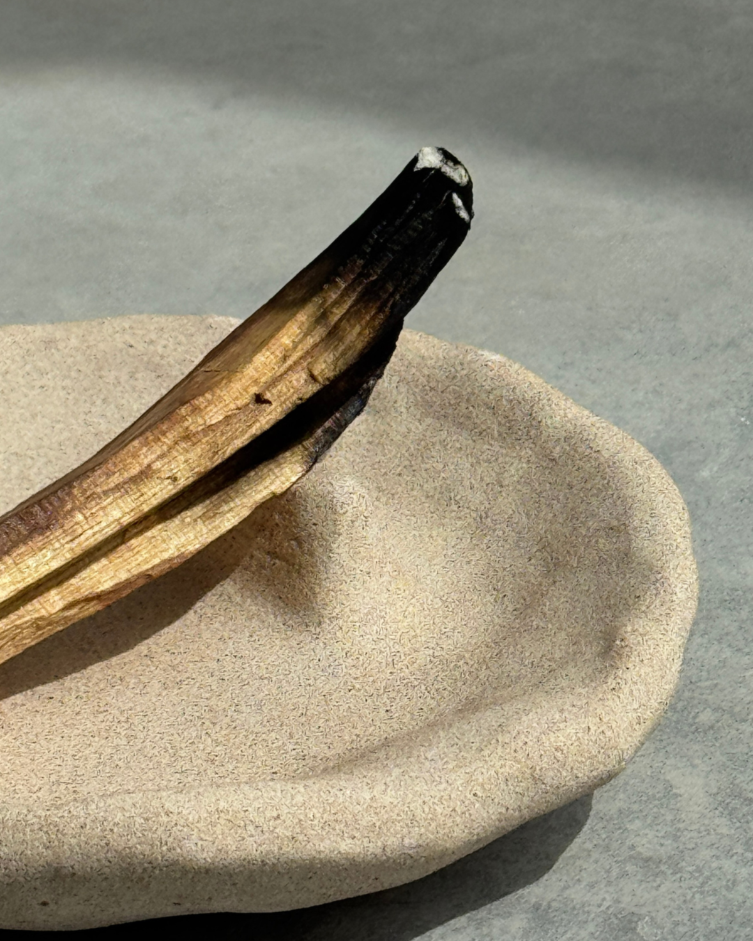 hand-poured micro concrete palo santo dish, modern stone-look finish, minimalist decor for palo santo burning, functional and sculptural home decor, almond beige color, elevated rest for palo santo stick, eco-friendly concrete dish, unique incense holder, contemporary decor for living room or meditation space, high-quality concrete home accessory, handmade dish for spiritual practices, versatile decorative object, premium concrete art piece, stylish and functional gift for wellness lovers, ginaladeco